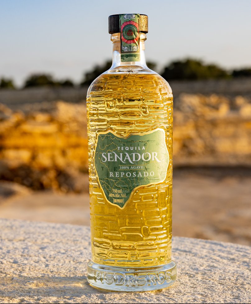 Senador Reposado tequila on a limestone ledge at golden hour